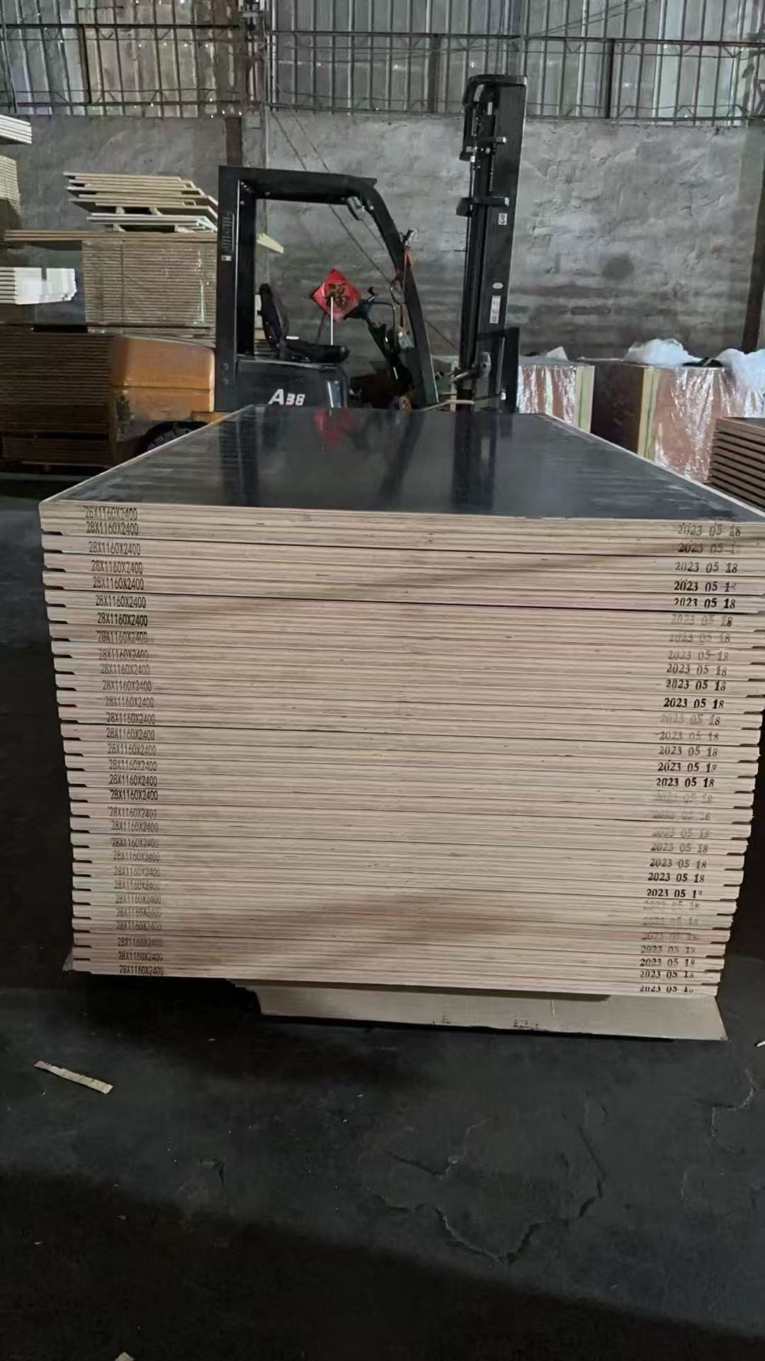 Black film-faced plywood sheets on forklift